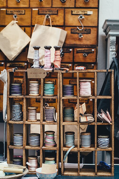 Colorful thread spools representing the craft